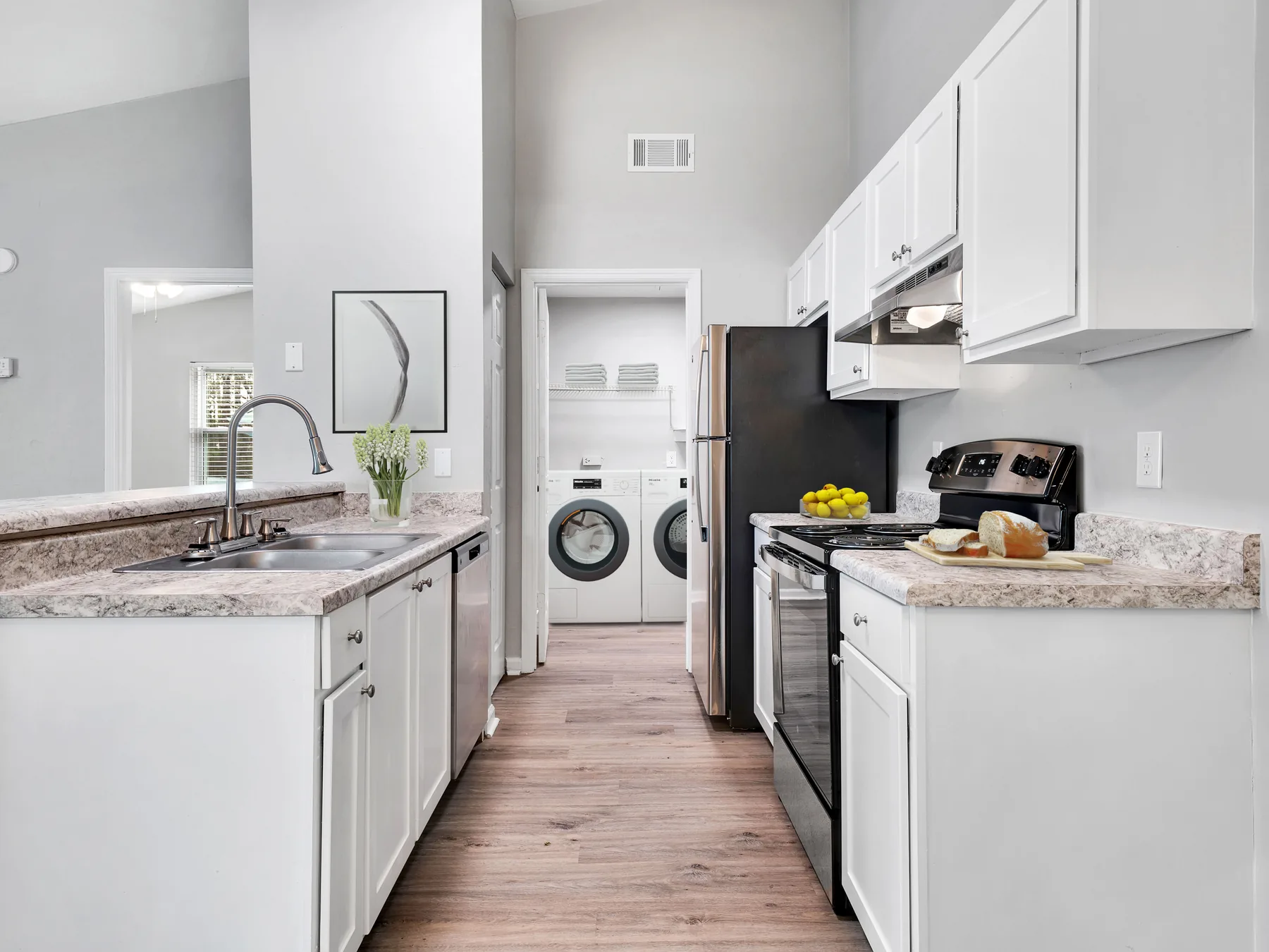Kitchen and dedicated laundry room with full-size washer and dryer at Crescent Ridge