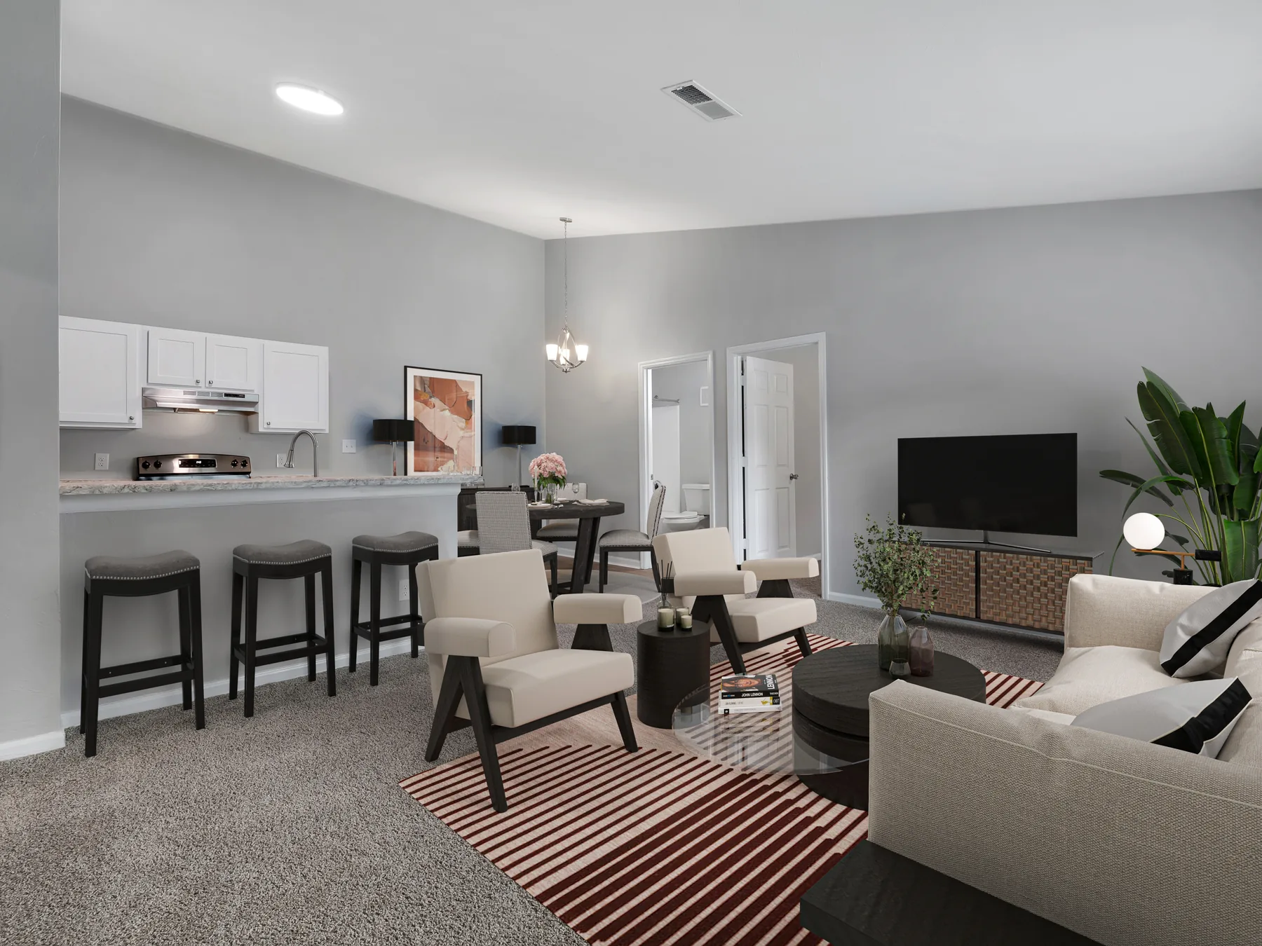 Staged living room and kitchen with vaulted ceiling and breakfast bar at Crescent Ridge Apartments, Tallahassee